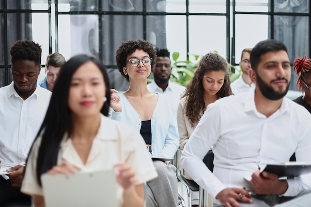 Conducts business training with a group of young people