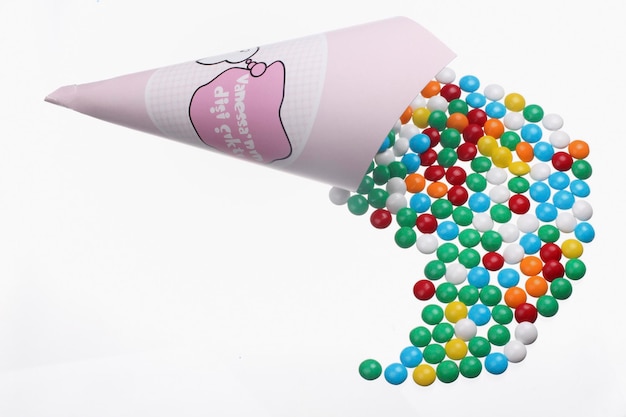 A cone of colorful balls is sprinkled with the word gum on it.