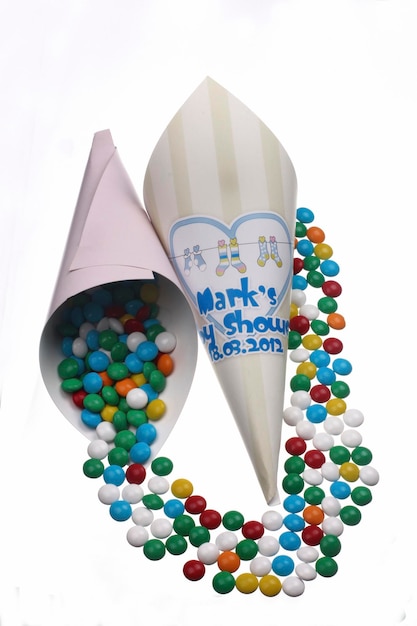 A cone of m & m is filled with colorful candy.