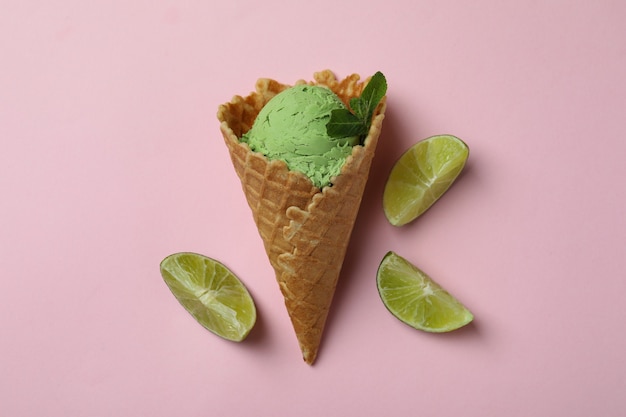 Cone of mint ice cream on pink