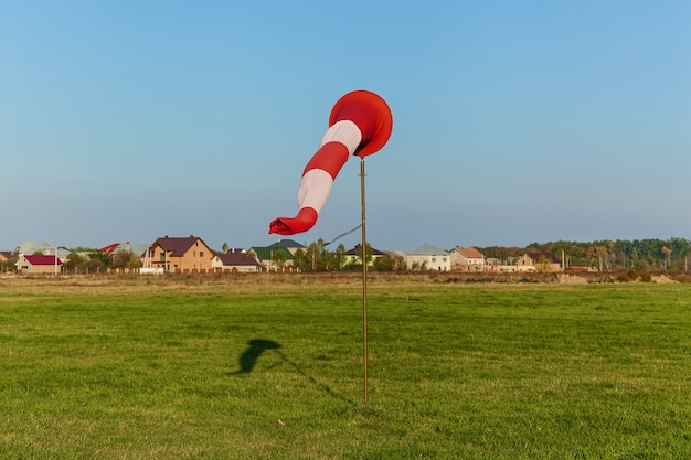 Photo cone on the runway on the background of grass and houses. cone on the runway.