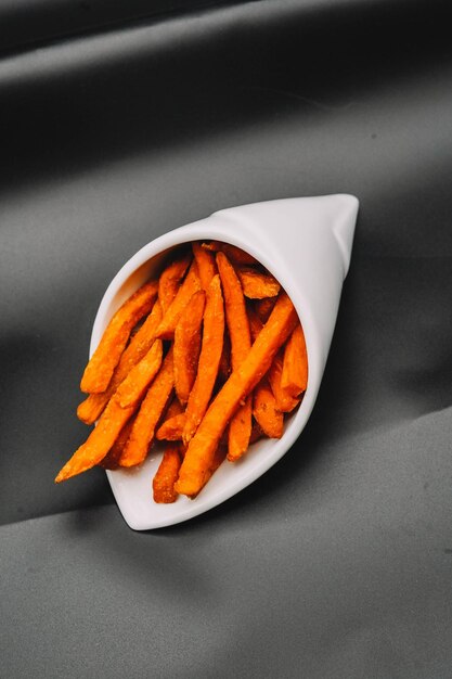 Cone with sweet potatoes and chips to eat and dip in sauce