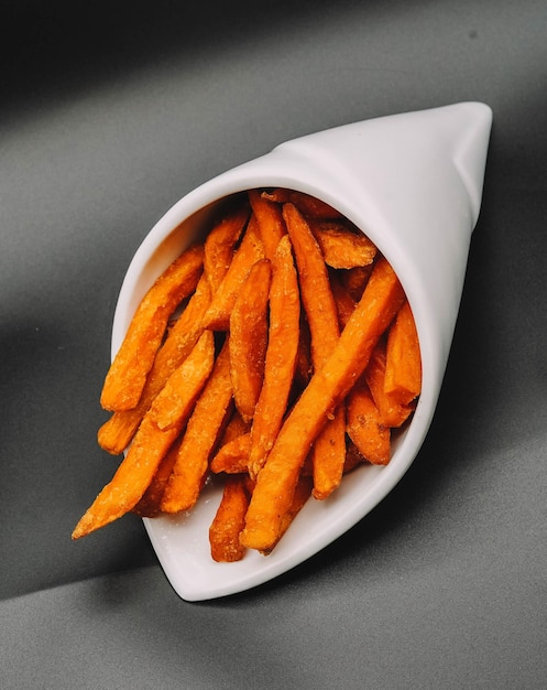 Cone with sweet potatoes and chips to eat and dip in sauce