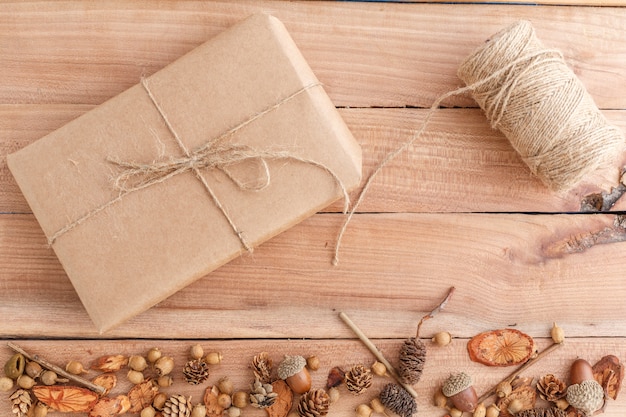 Cones, acorns and pieces of wood with a packed parcel