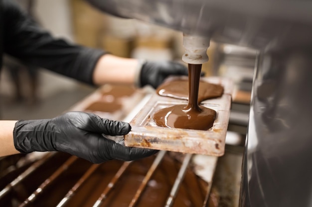 confectioner makes chocolate candies at sweetshop