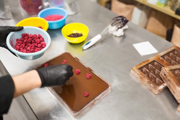 Photo confectioner makes chocolate dessert at sweetshop