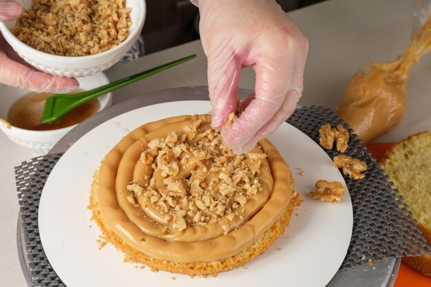 Confectioner putting walnuts in the brigadeiro filling (top view).