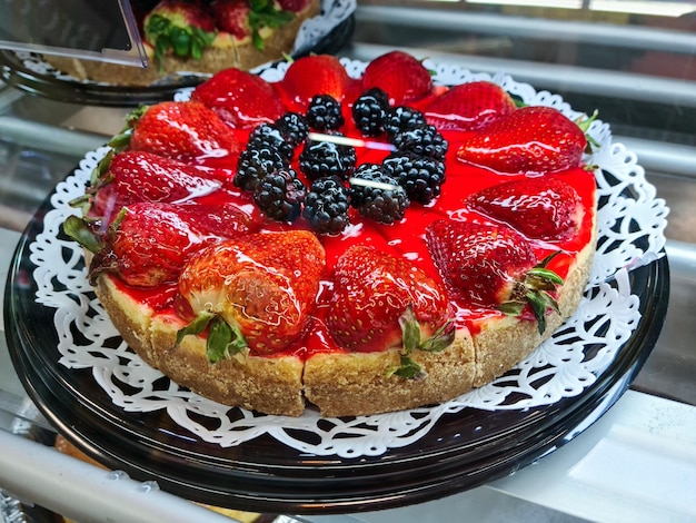 Confectionery showcase with strawberry cake and pies