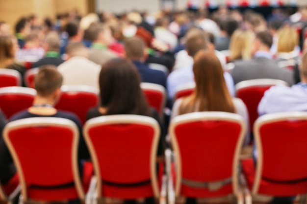 Conference blurred image group of business people listening at\
a conference defocused image