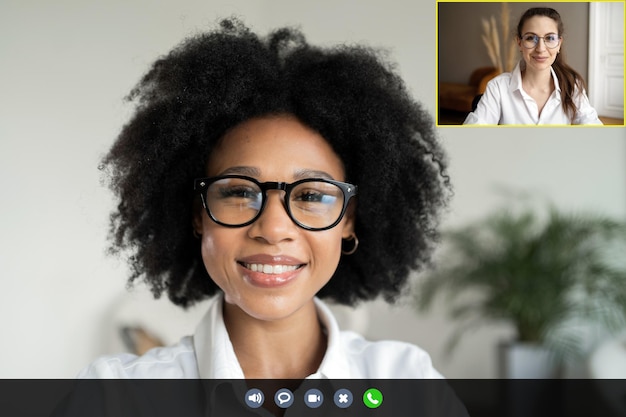 Photo conference remote video call a woman communicates with a colleague online laptop screen