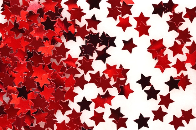 Photo confetti in the form of red stars as background texture