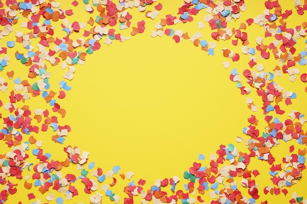 Confetti frame border on yellow paper background