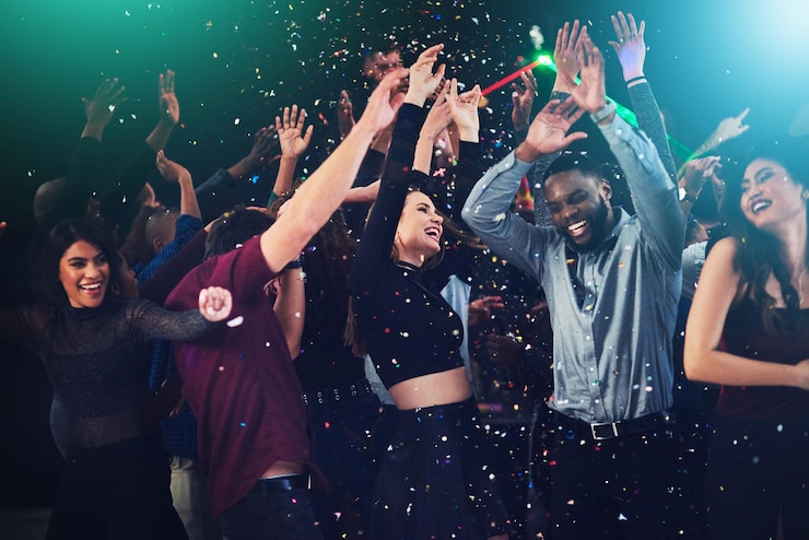 Photo confetti friends and dance in party for new year celebration with smile and fun at nightclub people disco lights and excited for festival with entertainment for memories break and enjoy for music