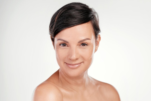 Confidence and beauty go hand in hand Cropped portrait of a beautiful mature woman posing against a grey background in studio