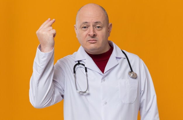 Confident adult man in doctor uniform with stethoscope pretending to hold something 