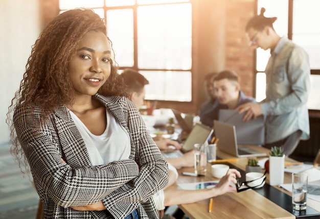 Confident african-american woman top manager posing at loft office, copy space