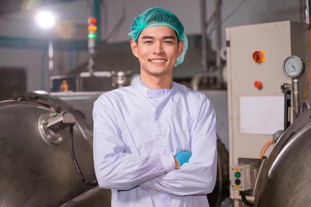 Confident asian man employee working in food factory industry\
asia worker work in food factory