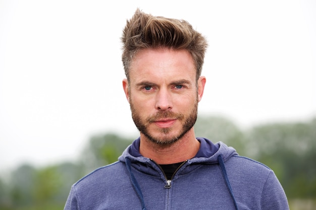 Confident attractive runner standing in park