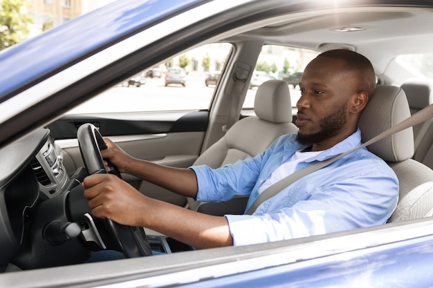 Premium Photo | Confident black man driving new car in city