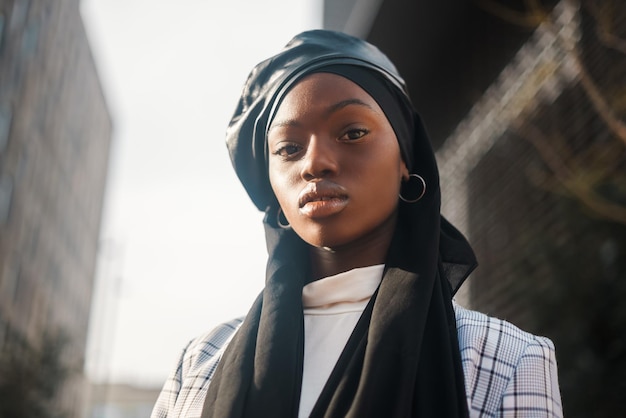 Confident black woman in traditional headscarf and formal wear