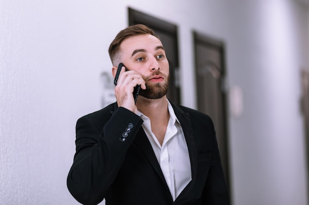 Confident boss having mobile phone conversation businessman tal