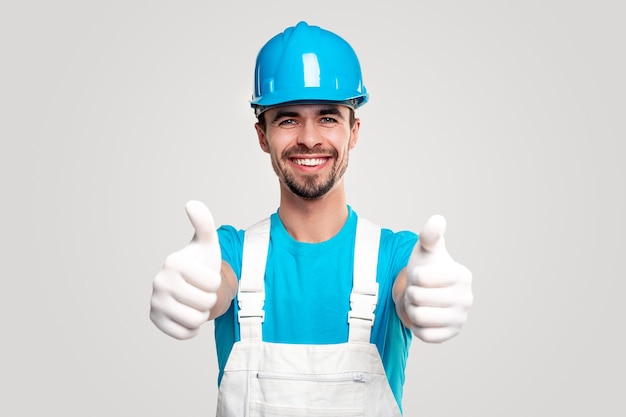 Confident builder in workwear showing thumbs up