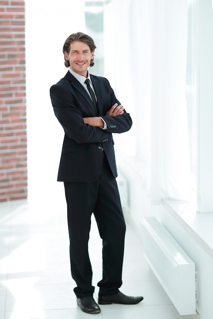 Confident business man on background of office