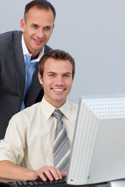 Confident business partners working together at a computer