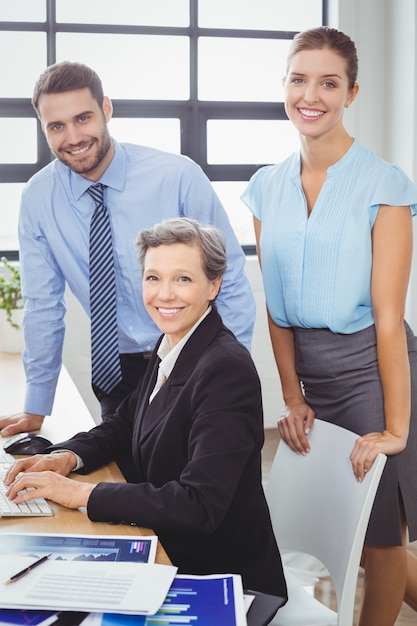 Confident business people at computer desk