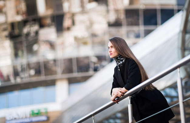 Confident business woman against a modern office building.