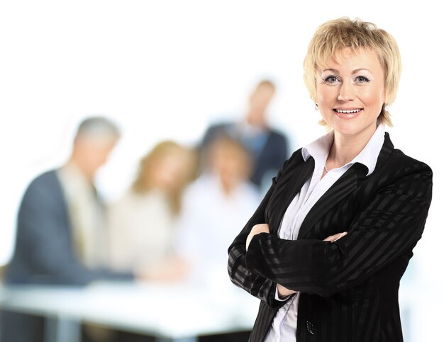 Confident business woman with team behind her