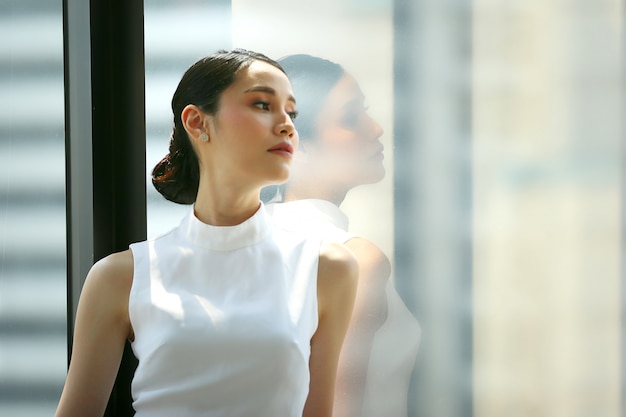confident business women standing by window