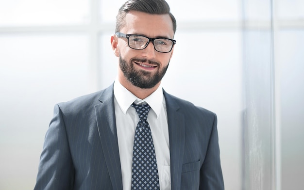 Confident businessman on background of office windo