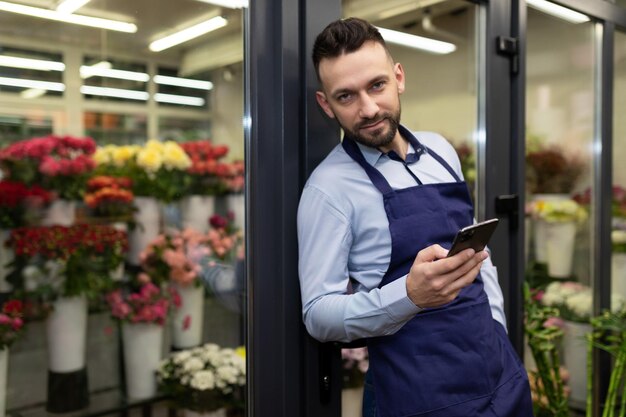 Confident businessman entrepreneur selling flowers and bouquets