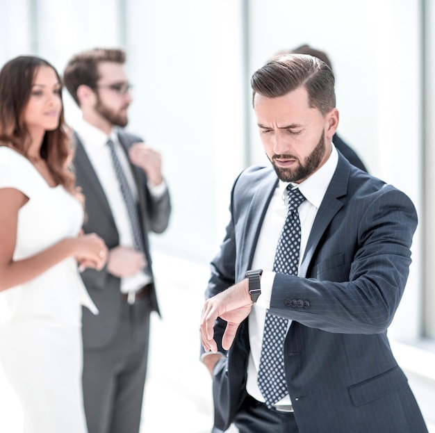 Confident businessman looking at his wristwatchbusiness concept