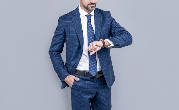 Confident businessman man in businesslike suit checking time time