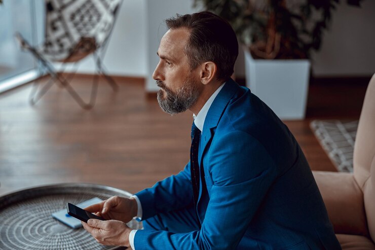 Confident businessman sitting on armchair cozy office space