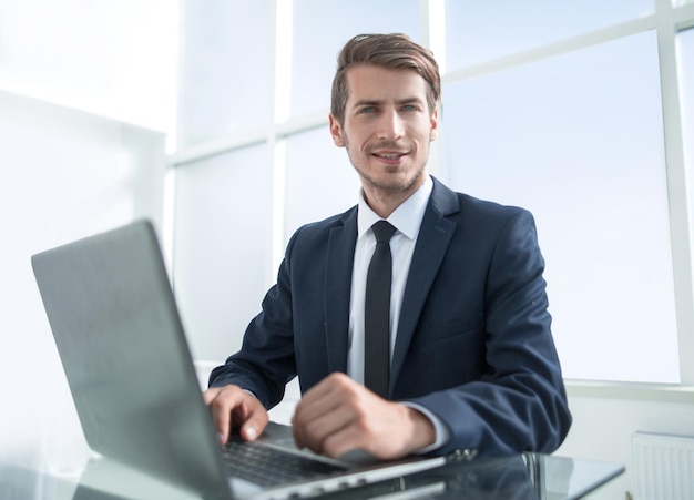 Confident businessman sitting at the office desk