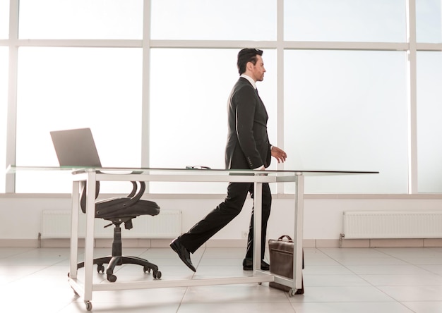 Confident businessman standing in a bright office