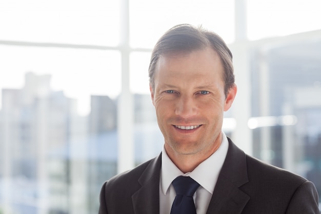 Confident businessman standing in an office