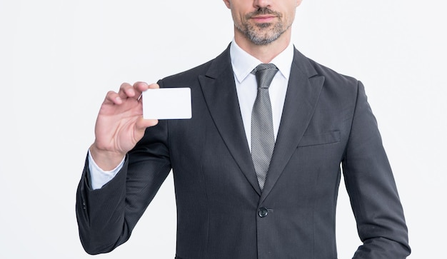 Confident businessman in suit hold business card isolated on white background