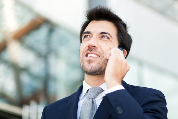 Confident businessman talking at the phone