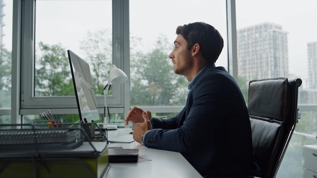 Confident businessman talking virtual meeting in office startup ceo working