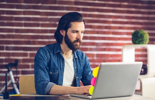 Confident businessman using laptop