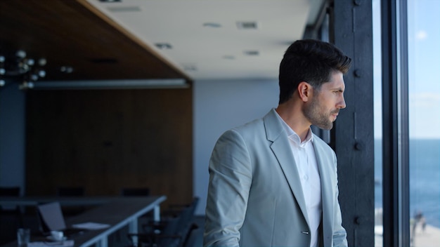 Confident businessman watching sea view Ceo thinking analyzing and waiting