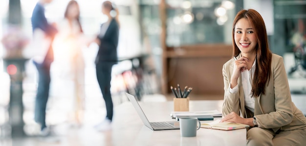 Confident Businesswoman Smiling At Camera Sitting In Modern Office