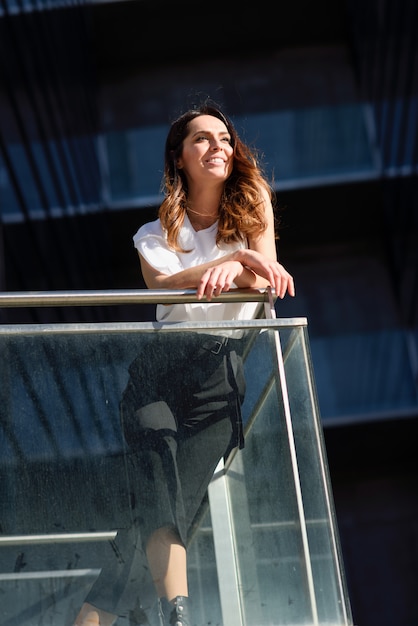 Confident businesswoman standing outside an office building.