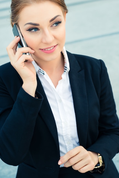 Confident businesswoman talking on business phone 