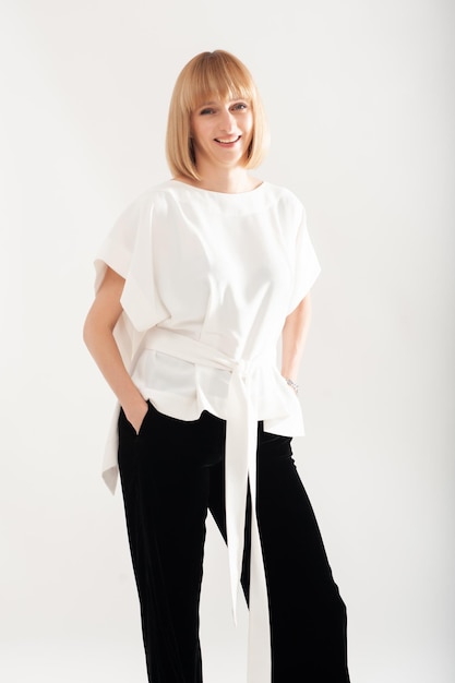 Confident businesswoman in white formal suit on background