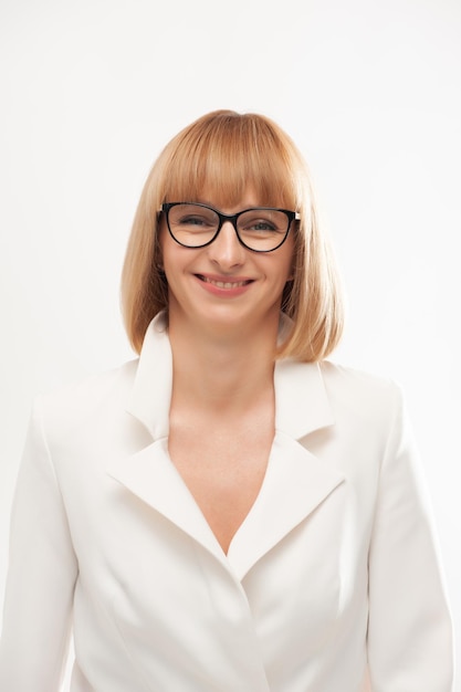 Confident businesswoman in white formal suit on background